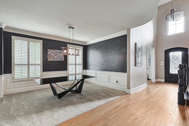 interior space featuring a chandelier, light wood-type flooring, and a wealth of natural light