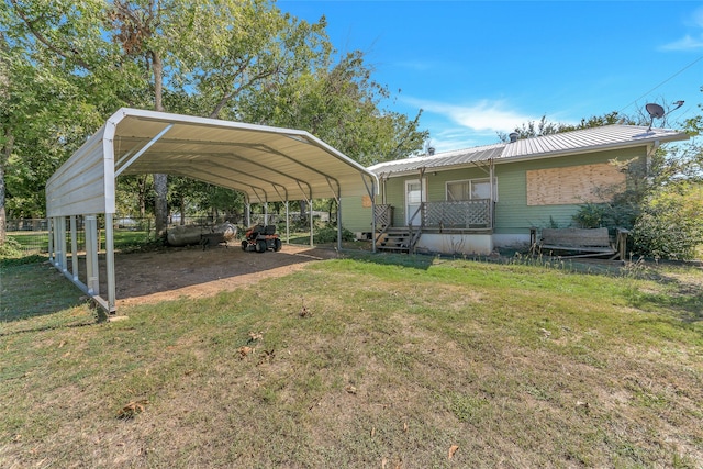 view of parking with a lawn and a carport