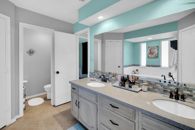 bathroom with decorative backsplash, tile patterned floors, vanity, and toilet