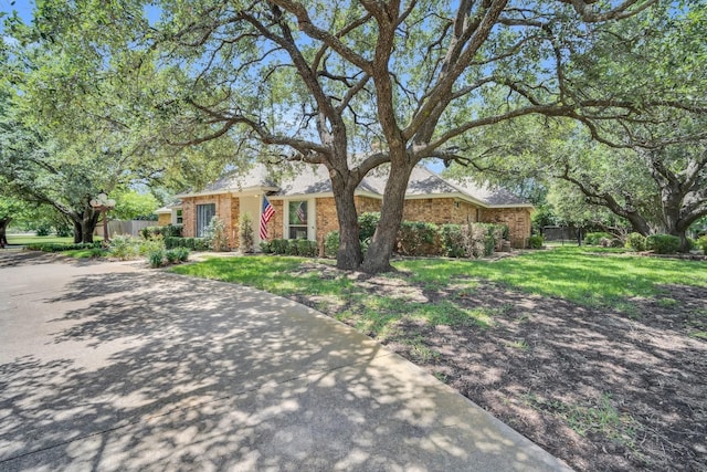 ranch-style home with a front lawn