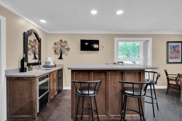 bar featuring ornamental molding and sink