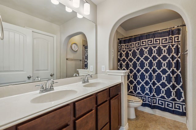 bathroom featuring vanity, tile patterned flooring, toilet, and curtained shower