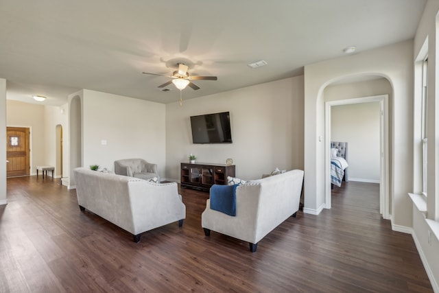 living room with ceiling fan and dark hardwood / wood-style floors