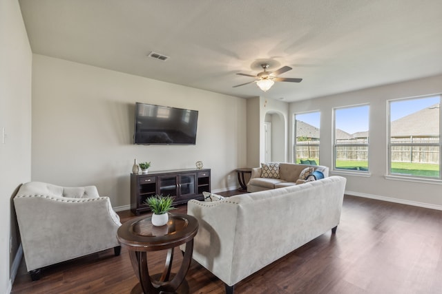 living room with ceiling fan and dark hardwood / wood-style flooring