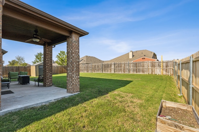 view of yard featuring ceiling fan, a shed, and a patio area