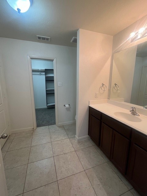 bathroom with vanity, toilet, and tile patterned floors