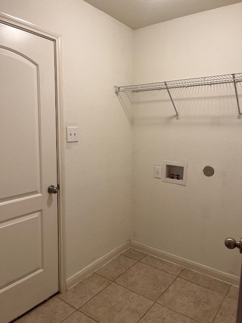 laundry area featuring tile patterned floors and washer hookup