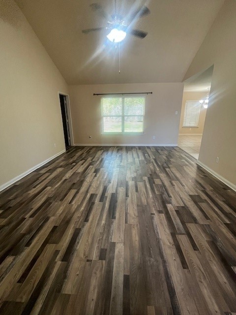 empty room featuring dark wood-type flooring, ceiling fan, and lofted ceiling