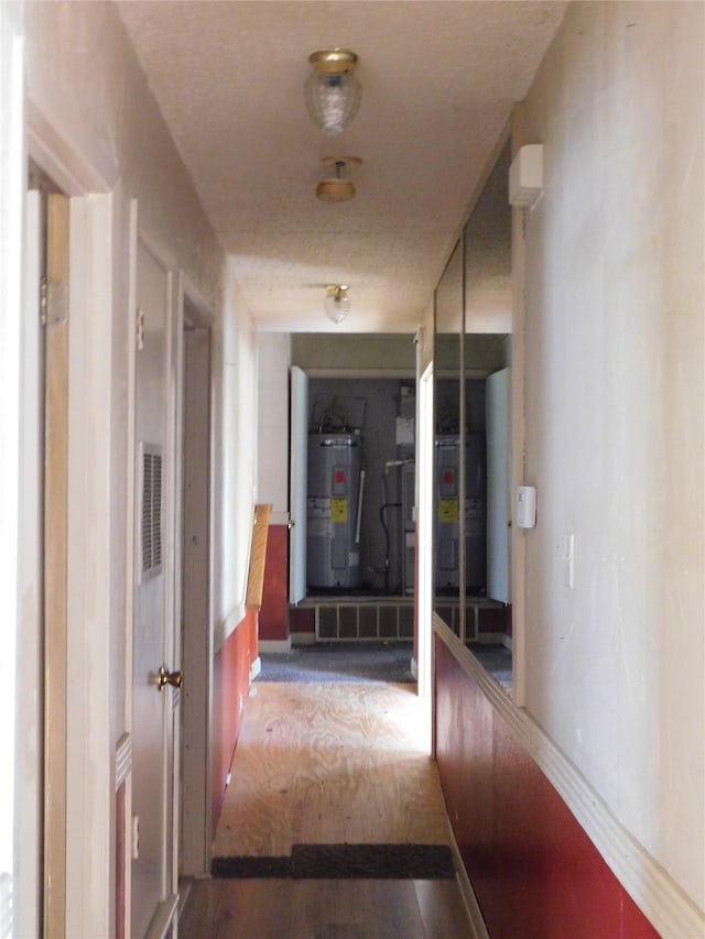 hall featuring hardwood / wood-style flooring and water heater