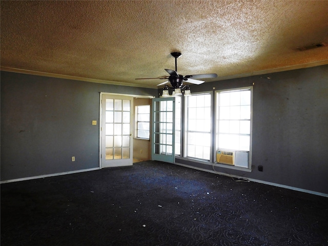 spare room featuring a textured ceiling, carpet floors, ceiling fan, and crown molding