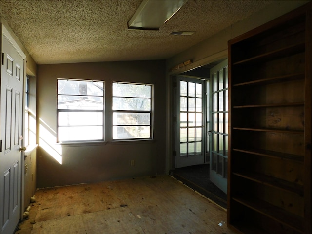 unfurnished sunroom with a wealth of natural light and vaulted ceiling