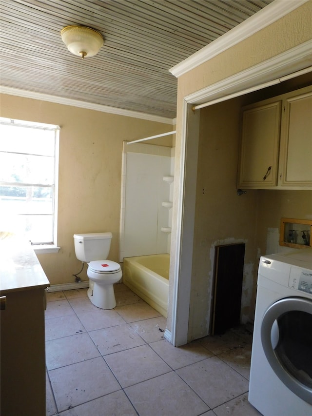 laundry area with light tile patterned floors, crown molding, and washer / clothes dryer