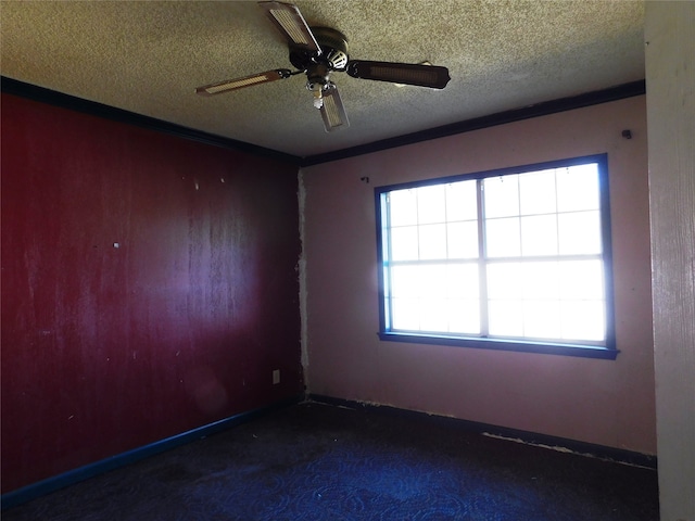 empty room with ceiling fan and a textured ceiling