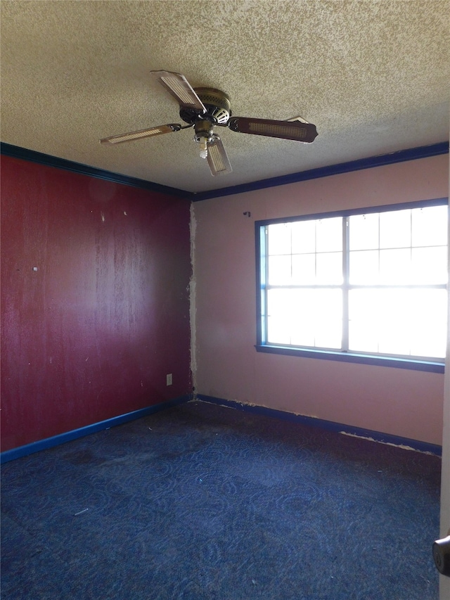 spare room featuring dark colored carpet, a textured ceiling, and ceiling fan