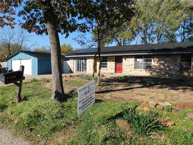 ranch-style home with solar panels and a garage