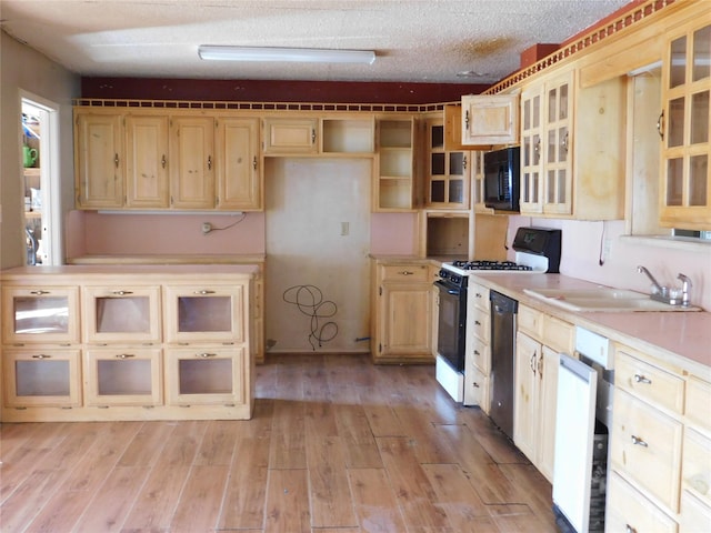 420 Lawson Ln, Pilot Point, TX 76258 - kitchen with black microwave, range with gas stovetop, dishwasher, light countertops, and light brown cabinetry