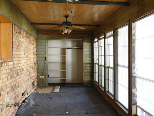 unfurnished sunroom featuring ceiling fan and wooden ceiling