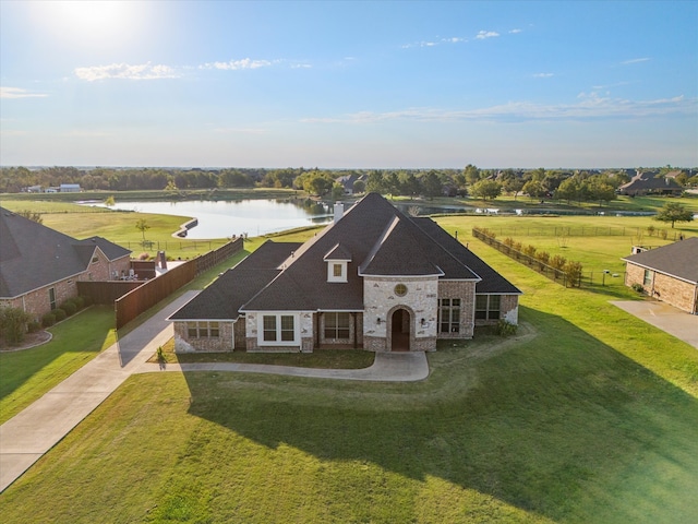 10270 County Road 213, Talty, TX 75126 - view of front facade featuring a water view, stone siding, and concrete driveway
