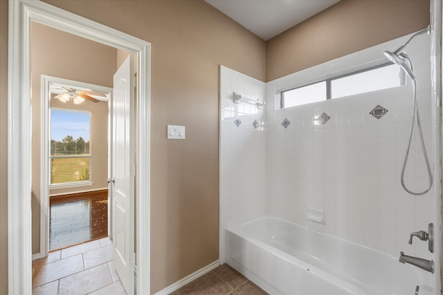 bathroom with tiled shower / bath, plenty of natural light, and tile patterned flooring