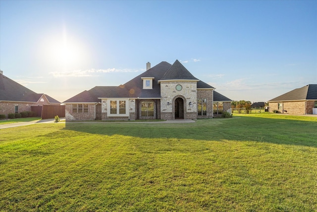 french country style house featuring a front lawn