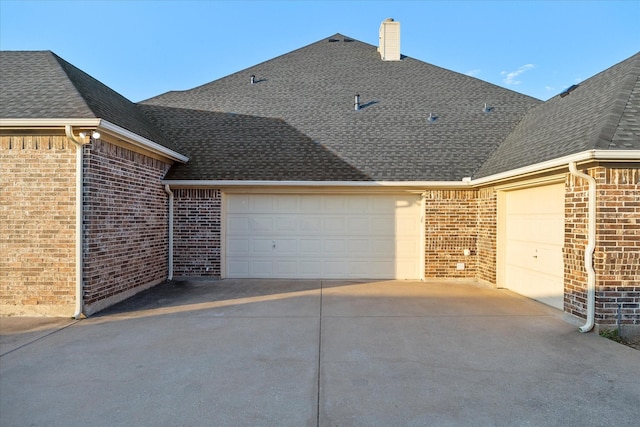 10270 County Road 213, Talty, TX 75126 - view of side of property featuring an attached garage, brick siding, concrete driveway, a shingled roof, and a chimney