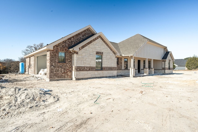 view of front facade featuring covered porch and a garage