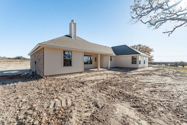 back of property with a patio