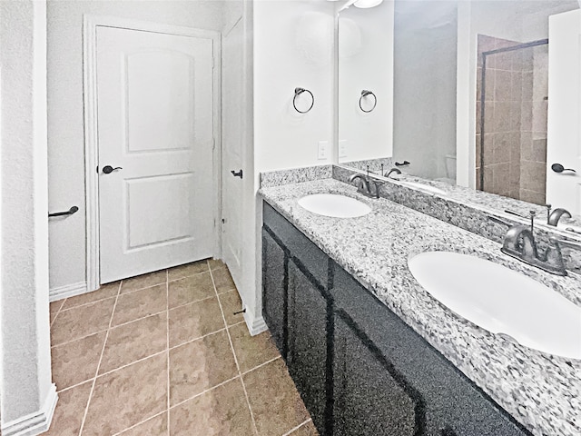 bathroom with tile patterned flooring, vanity, and a shower with shower door