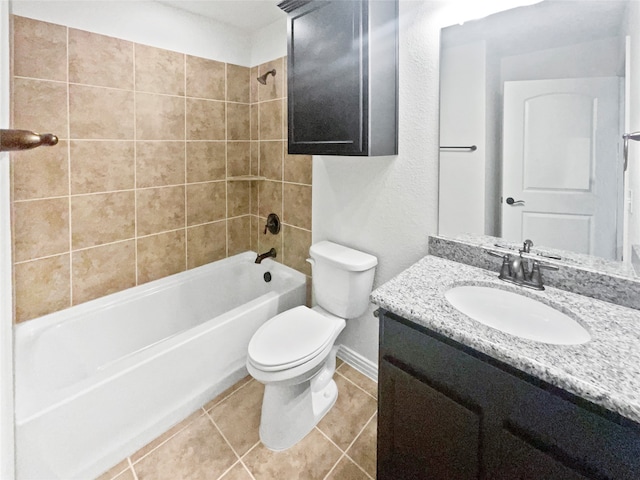 full bathroom with tile patterned flooring, tiled shower / bath combo, vanity, and toilet