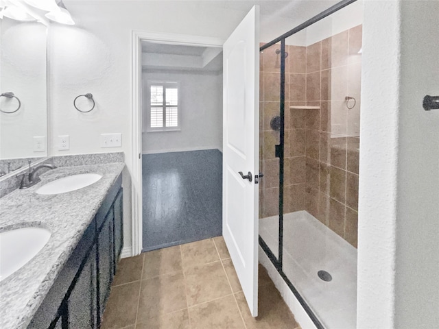 bathroom with walk in shower, tile patterned floors, and vanity