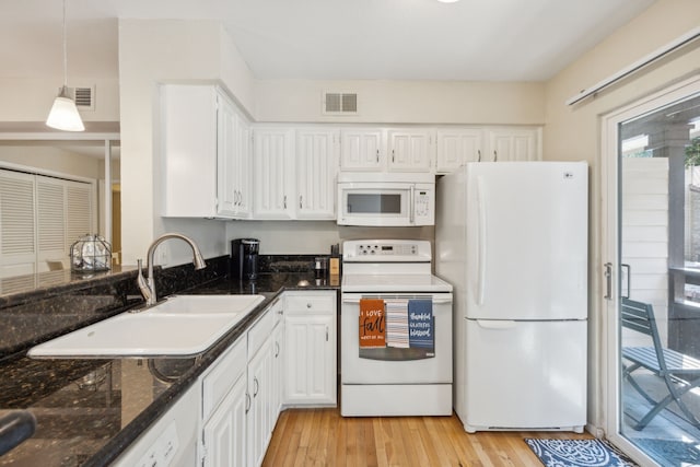 kitchen featuring pendant lighting, white appliances, white cabinets, and light hardwood / wood-style flooring