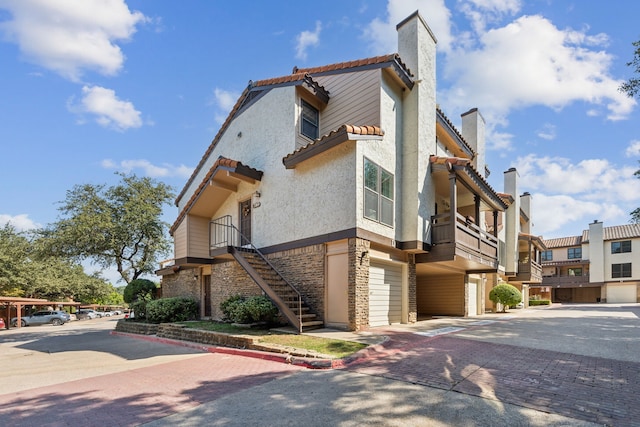 view of home's exterior featuring a garage and a balcony