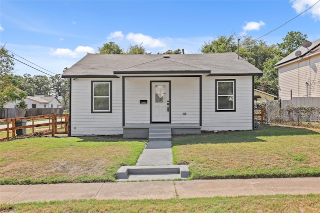 bungalow-style home featuring a front lawn