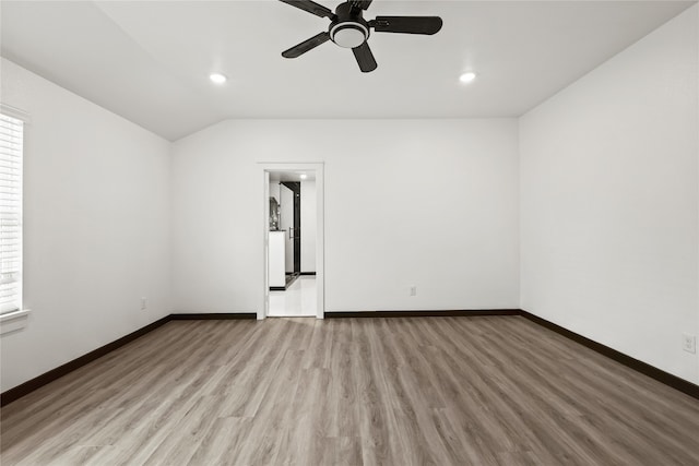 unfurnished room featuring vaulted ceiling, light wood-type flooring, and ceiling fan