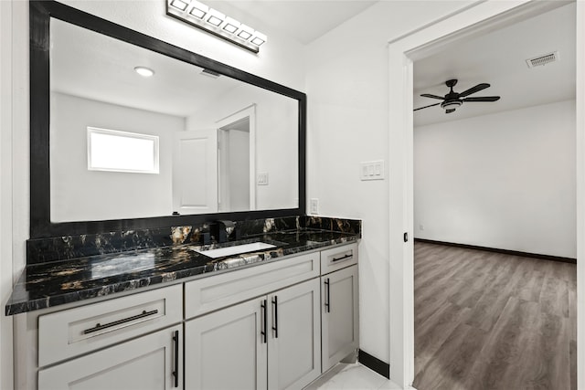 bathroom with ceiling fan, vanity, and hardwood / wood-style flooring