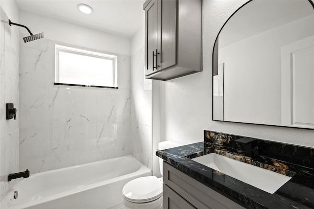 full bathroom with tiled shower / bath combo, vanity, and toilet