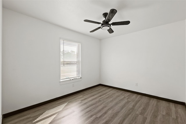 unfurnished room with hardwood / wood-style flooring and ceiling fan