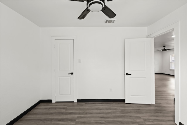 unfurnished bedroom with ceiling fan and dark hardwood / wood-style flooring