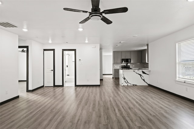 unfurnished living room with light hardwood / wood-style flooring and ceiling fan