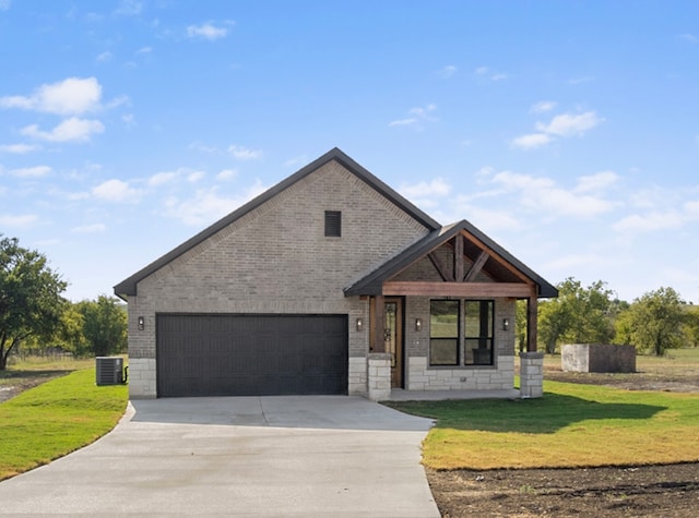 view of front of house featuring a garage and a front yard