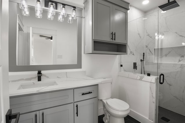 bathroom with toilet, vanity, and an enclosed shower