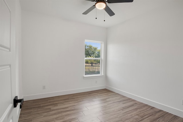 spare room with ceiling fan and light wood-type flooring