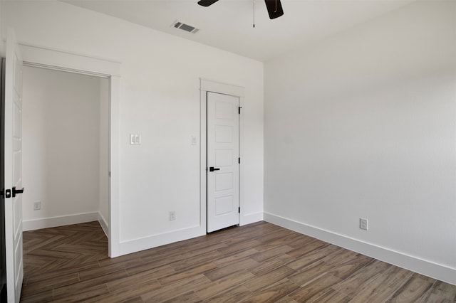 unfurnished bedroom featuring dark hardwood / wood-style flooring and ceiling fan