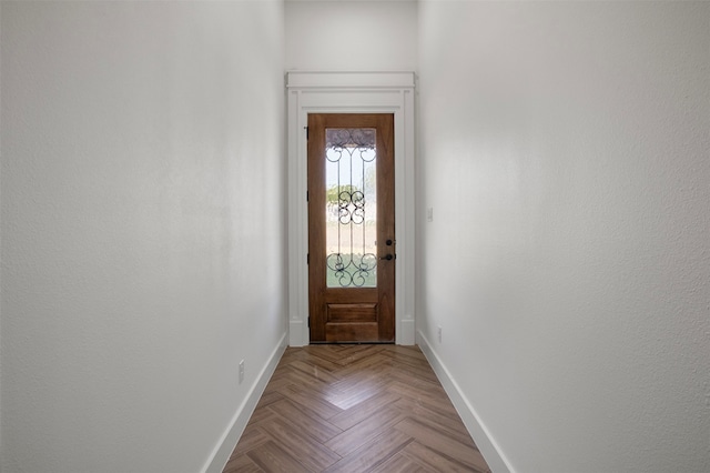 doorway to outside featuring light parquet flooring