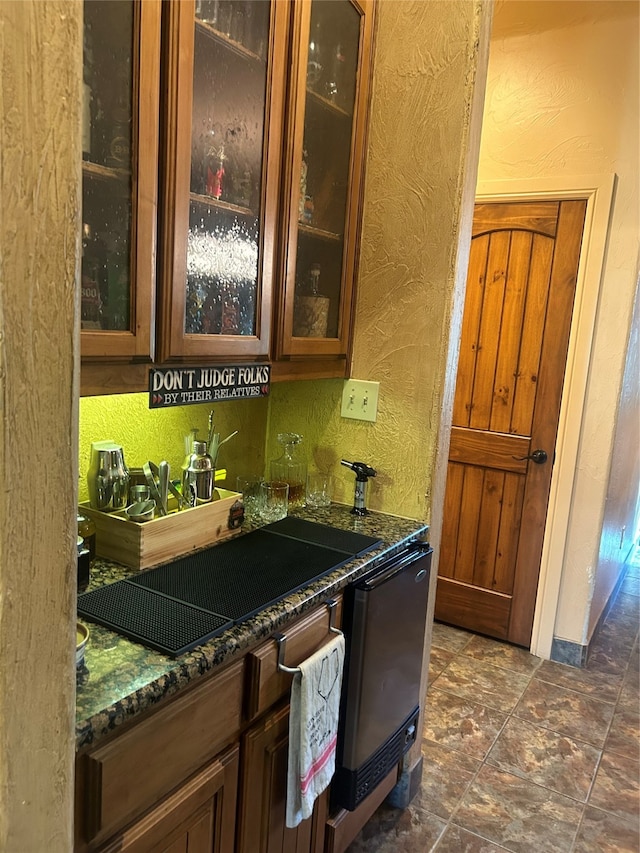 bar featuring dark stone countertops