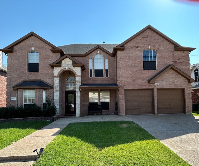 view of front of property with a garage and a front yard