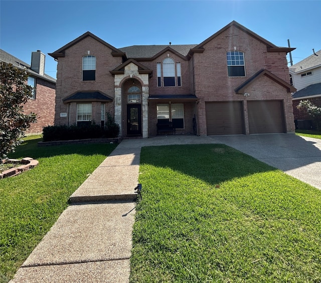 view of front facade with a front yard and a garage