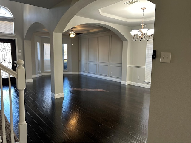 entryway featuring dark hardwood / wood-style floors, a raised ceiling, and plenty of natural light