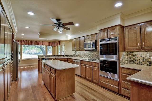 kitchen featuring stainless steel appliances, tasteful backsplash, ornamental molding, and light hardwood / wood-style floors