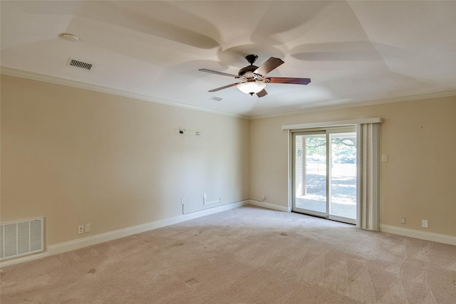 carpeted spare room featuring ceiling fan and ornamental molding